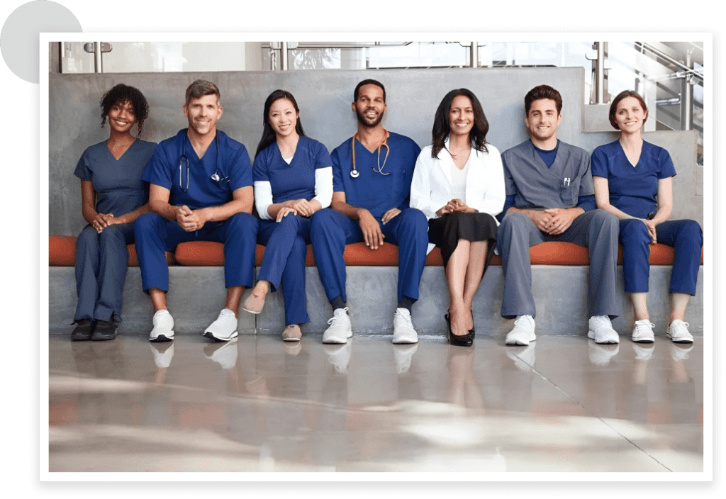 A Group Of People In Scrubs Sitting Together