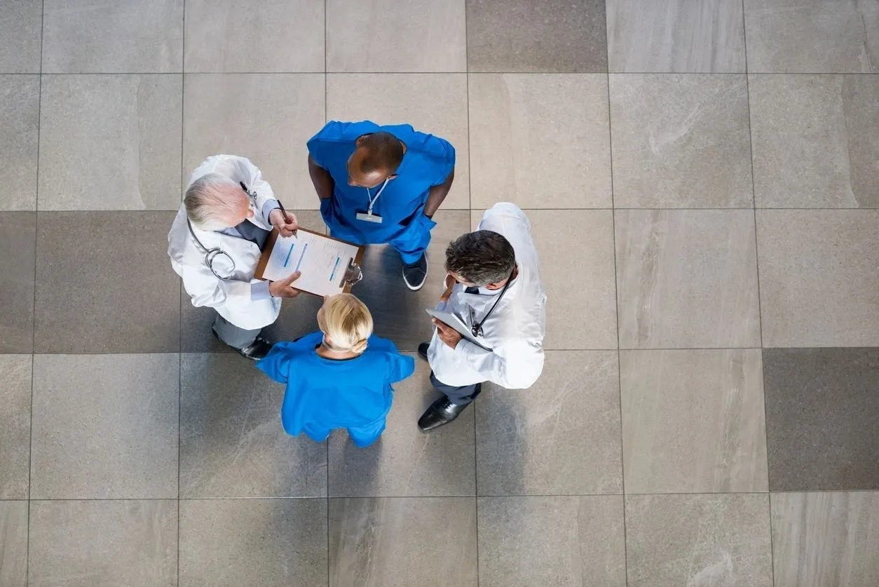 Four Doctors Talking To Each Other in A Group